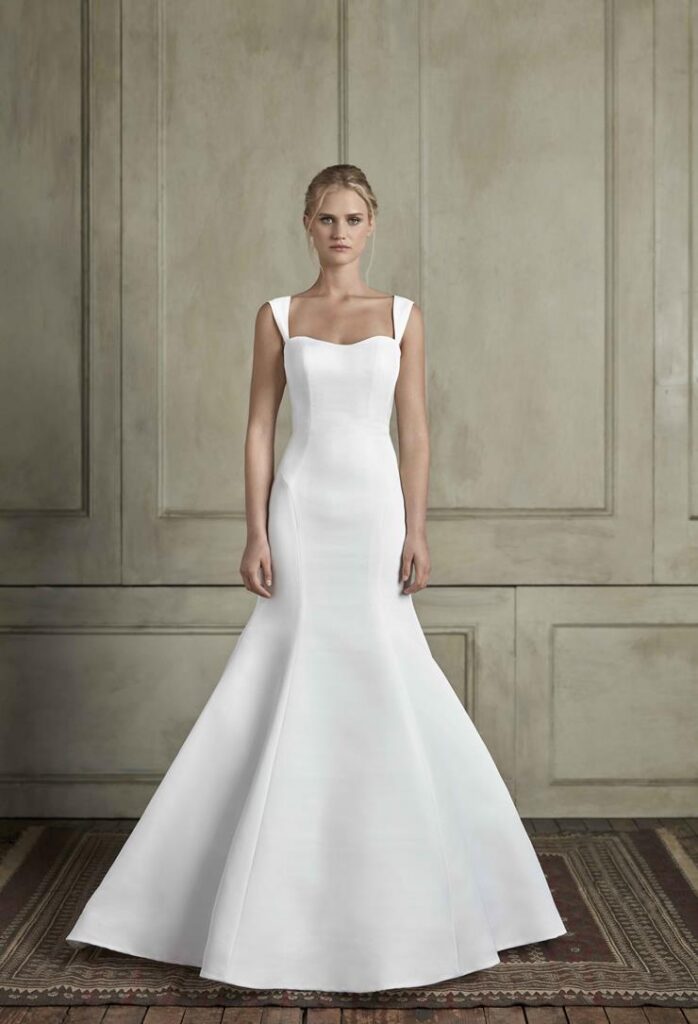 Minimalist structured satin mermaid wedding gown with wide square straps and a sweetheart neckline at La Mariée Boutique Tulsa