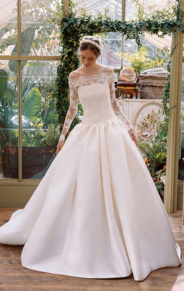 Off-the-shoulder lace long-sleeve ball gown wedding dress with a full satin skirt at La Mariée Boutique Tulsa