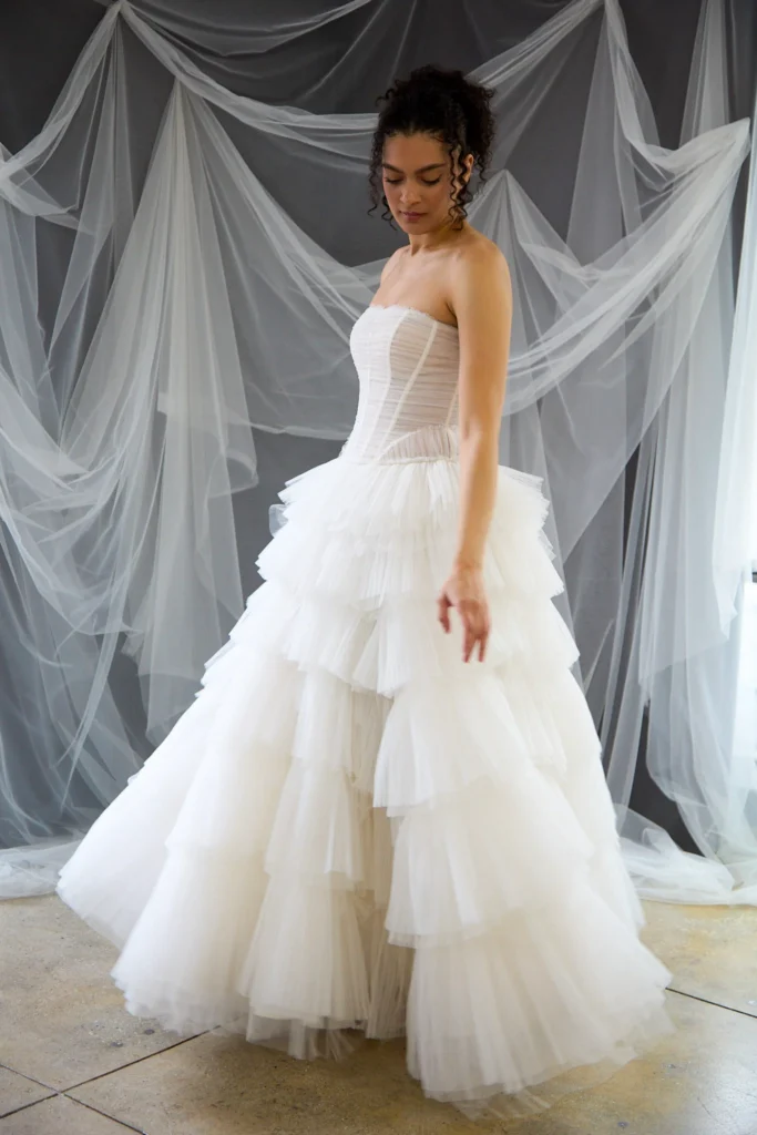Strapless tulle corset wedding gown with tiered ruffle ball skirt at La Mariée Boutique Tulsa