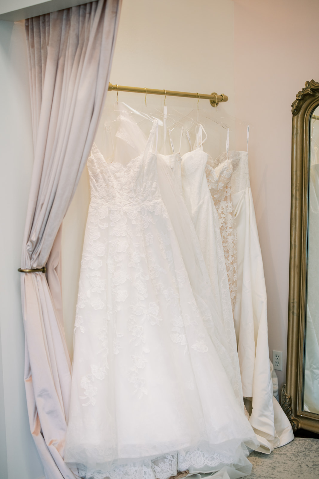 Gowns waiting in a La Mariée fitting room